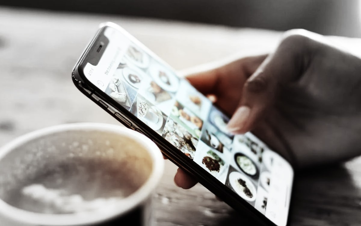 Marketing Your Brand Using Social Media - Person viewing social media on phone